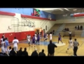 High school basketball player throws down monster dunk over guy who never saw him coming.