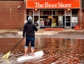 Not even a flood can stop this man from his beer.