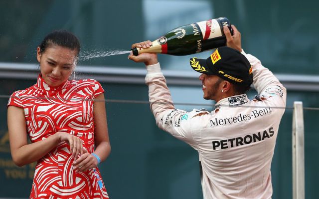 Busting open the champagne to celebrate victory but gives this poor woman a facial.