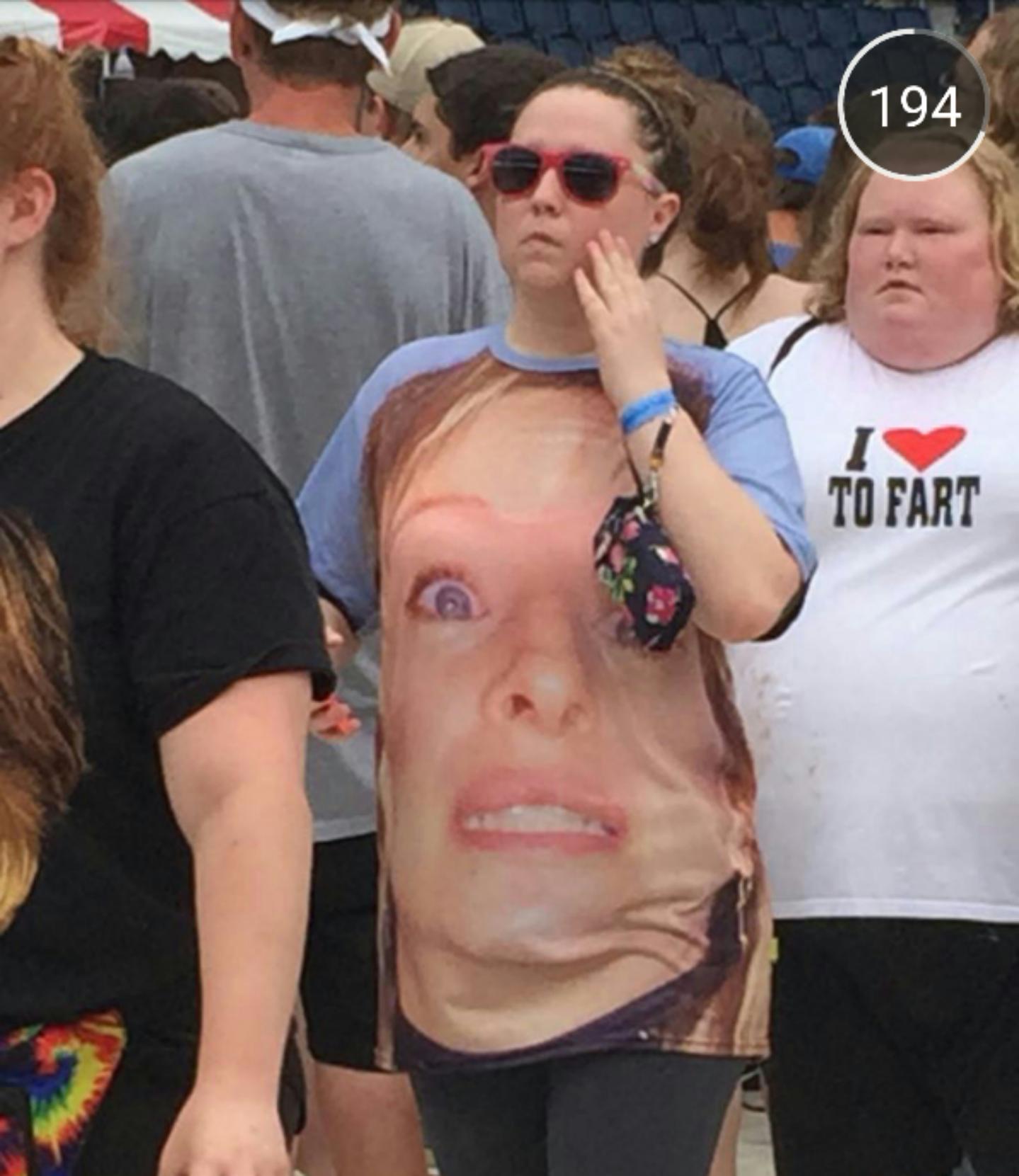 After you check out the woman's shirt with the huge face, look at the woman behind her.