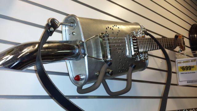 Custom guitar made from a muffler and exhaust tip.