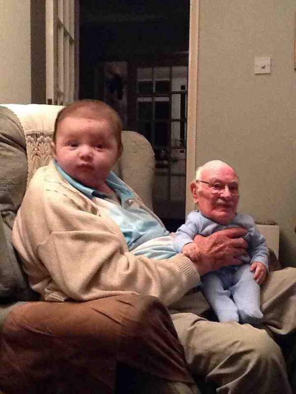 Cute Picture Of A Baby Holding Grandpa On His Lap.