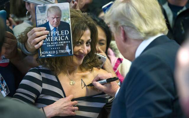 Donald Trump signing some boob.