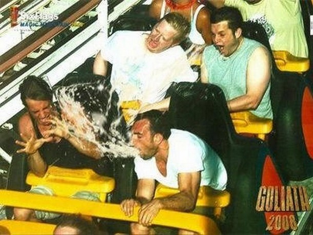 Guy On Roller Coaster Pukes Up His Lunch And The Other Riders Get A Taste.