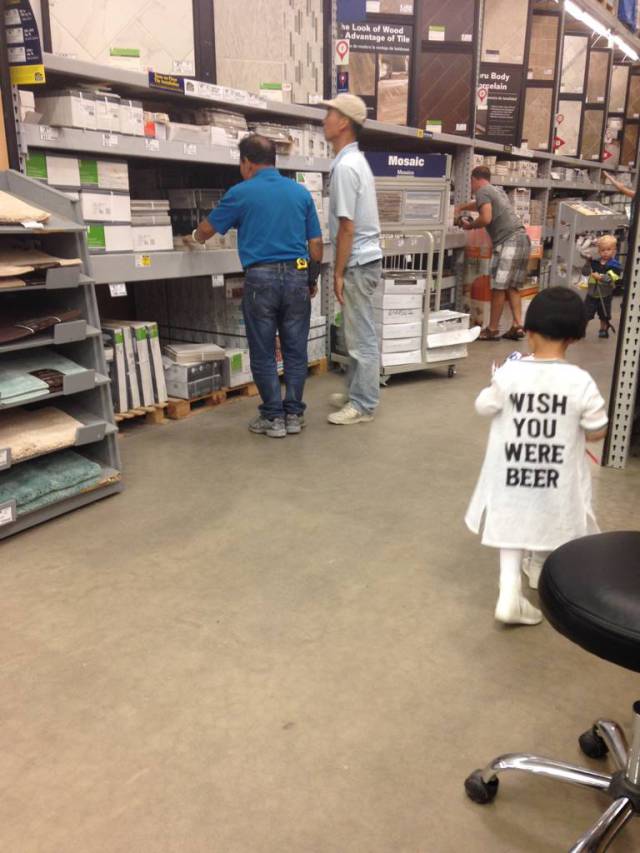 Kid wearing a wish you were beer shirt was obviously dressed by her Dad that day.