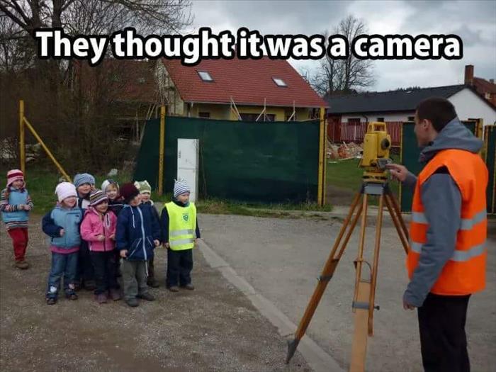 Kids thought this land surveyor was taking a picture.