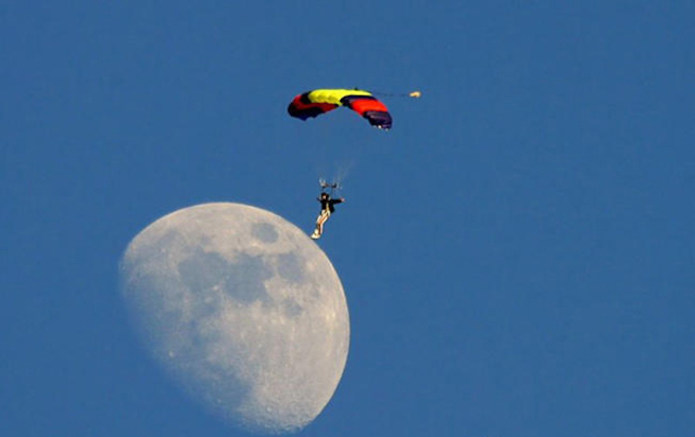 Man Lands On The Moon Using A Parachute. 