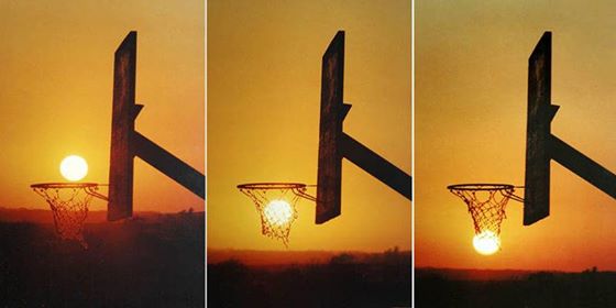 The sun playing a game of hoops drills a 3 pointer from down town.