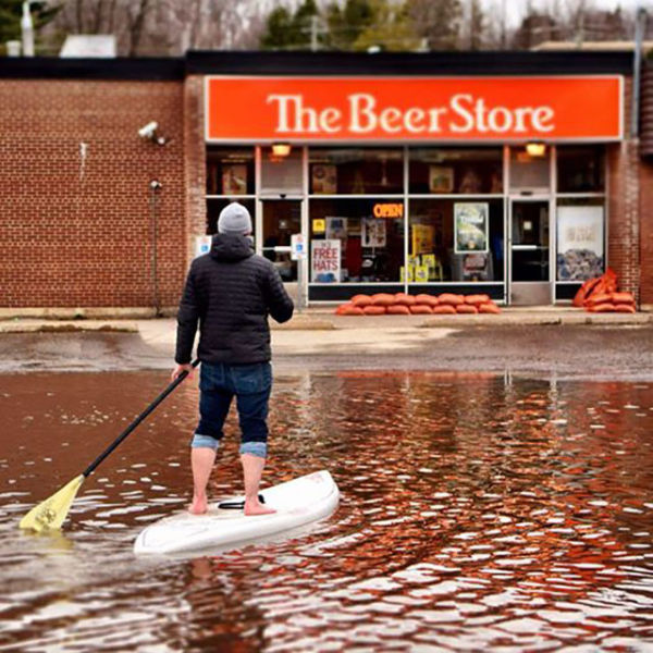 Not even a flood can stop this man from his beer.