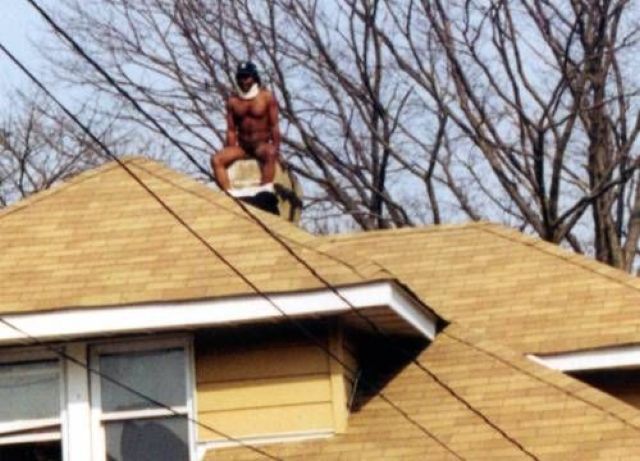 This man appears to be taking a dump down someones chimney. I wonder if it was even Christmas?
