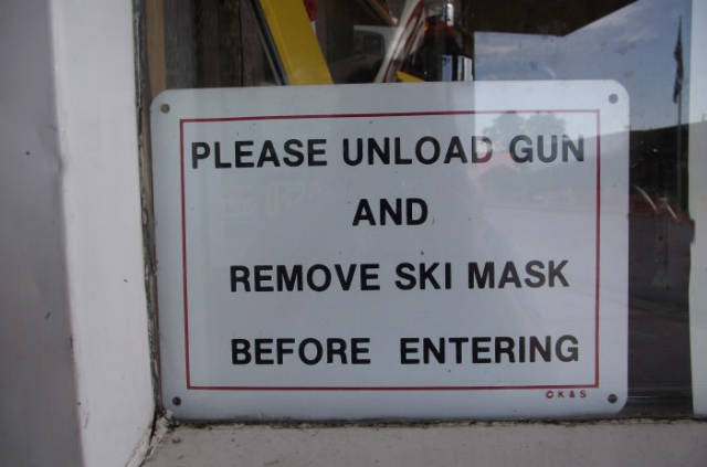 Please unload gun and remove ski mask before entering.
