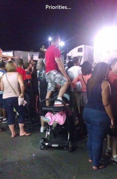 Standing on top of a baby stroller with your child in it to get a better view shows a priority problem.