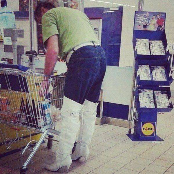 This guy is a real trendsetter with his knee high heeled boots over his jeans.