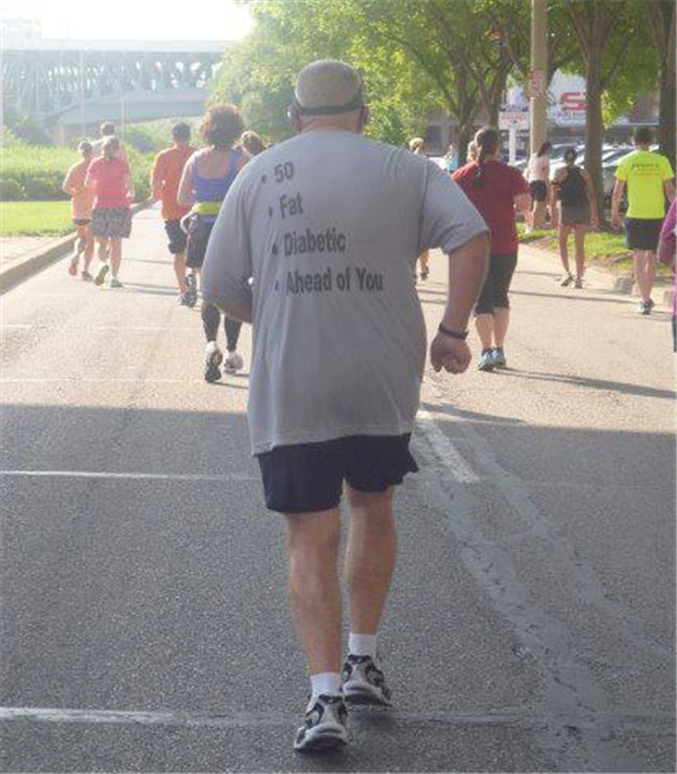This man running in a marathon has a great motivational shirt for the runners behind him.