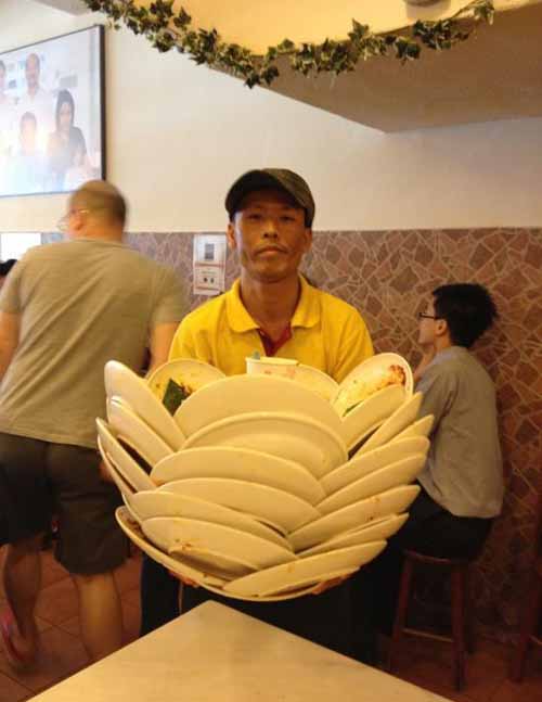 This waiter has mad skills especially since the plates probably weigh more than he does.