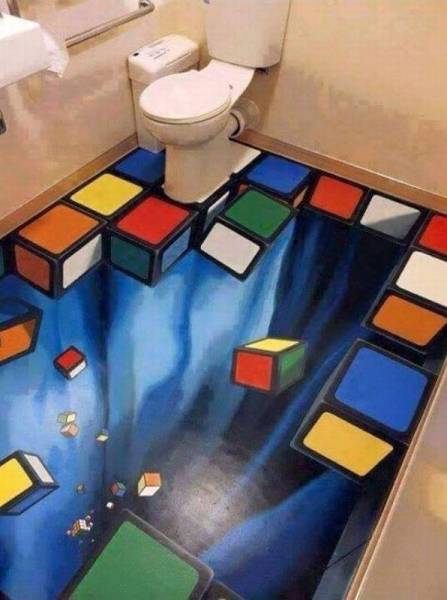 Trippy bathroom floor with falling Rubik's Cube pieces.