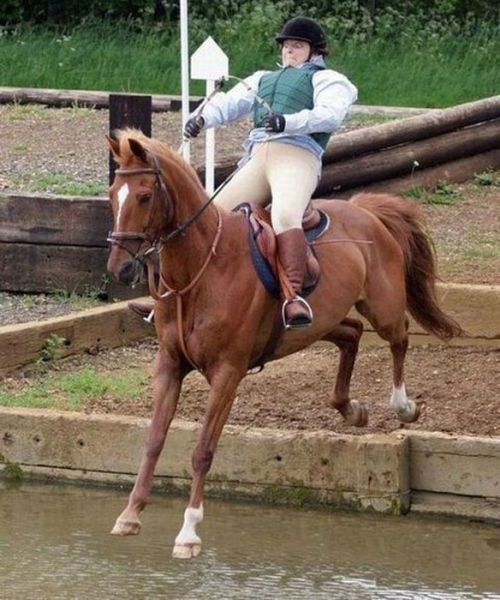 This woman riding on her horse does not look very calm about the upcoming landing.