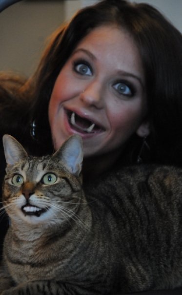 Woman and her cat swap teeth.