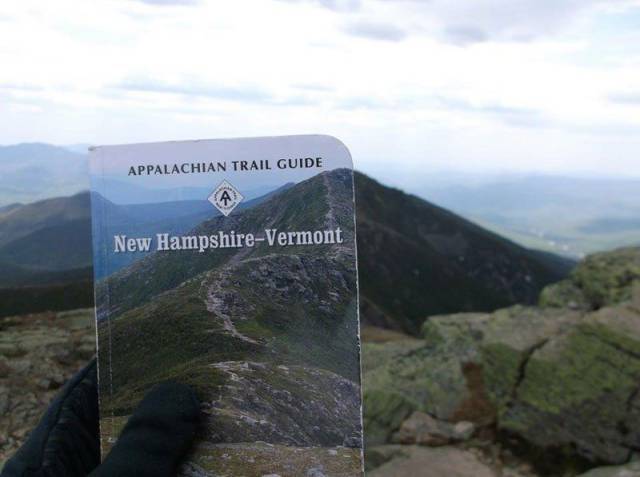 Appalachian Trail Guide held up at the exact location the cover picture was taken.