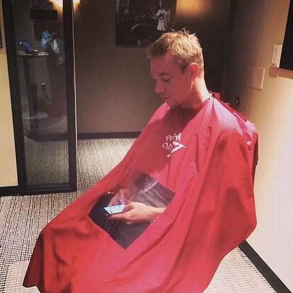 Barber gowns to keep the hair off you now have a see through window for those who can't sit still without staring at their phone.