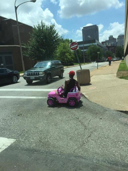 Cruising the hood in a Power Wheels Barbie Jeep.