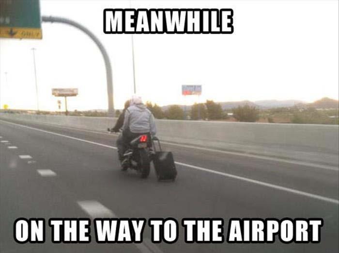 Headed to the airport on a motorcycle.