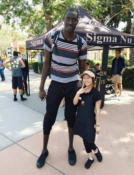7-foot 6-inch Mamadou N'Diaye with one of the shortest girls on campus.