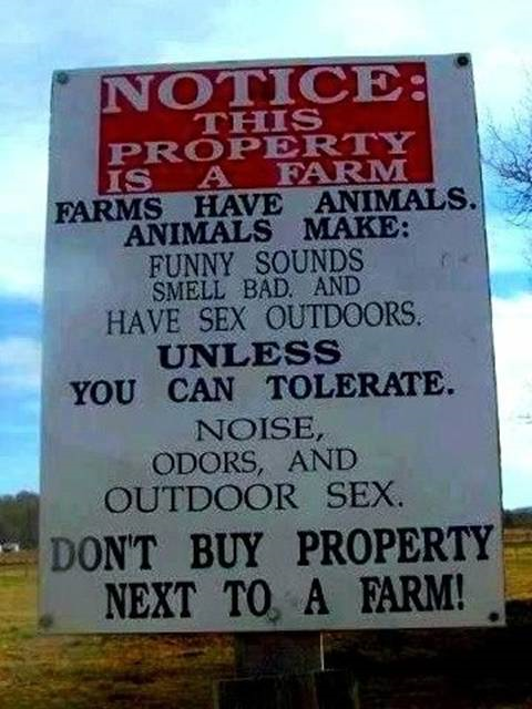 Sign for those city slickers looking to buy property next to a farm.