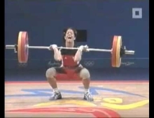 Female Weightlifter Struggles So Hard To Get The Weights Up She Springs A Leak. Notice The Casual Attempt To Cover The Pee Leakage Like A Cat In A Litter Box.