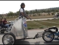 Man Riding In A Chariot Pulled By A Motorcycle Controlled By Strings In Sturgis, South Dakota.