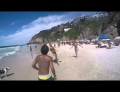 Dog shows off its soccer juggling skills with some friends at the beach.