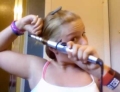 Curling iron tutorial shows how not to do it unless you want to burn your hair off.