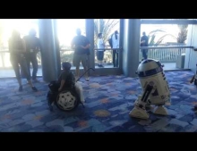 Remote control R2-D2 brings great joy to a boy in a wheelchair at the Star Wars Celebration Convention.