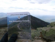 Appalachian Trail Guide held up at the exact location the cover picture was taken.