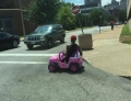 Cruising the hood in a Power Wheels Barbie Jeep.