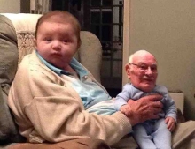 Cute Picture Of A Baby Holding Grandpa On His Lap.