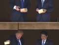 Donald Trump and Shinzo Abe feed the koi fish.