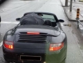 Driving a Porsche Convertible in the rain with the top down is no problem for this driver.