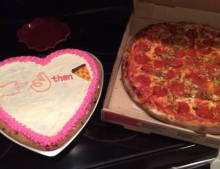 Heart shaped cake with a secret message and pizza. Romance in its finest form.