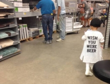 Kid wearing a wish you were beer shirt was obviously dressed by her Dad that day.