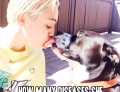 Miley Cyrus kissing her dog on the lips.