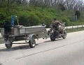Motorcycle towing boat is not something you see everyday.