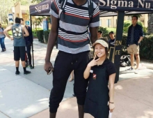 7-foot 6-inch Mamadou N'Diaye with one of the shortest girls on campus.