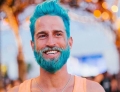 There is a new fad happening where men dye their hair and beards vibrant colors. This guy is going for the Smurf look.