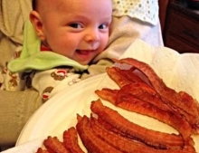 This baby is already a bacon lover.
