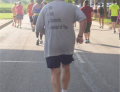 This man running in a marathon has a great motivational shirt for the runners behind him.