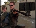 Vintage behind the scenes photo of Arnold Schwarzenegger taking a selfie in the movie Terminator 2: Judgement Day.