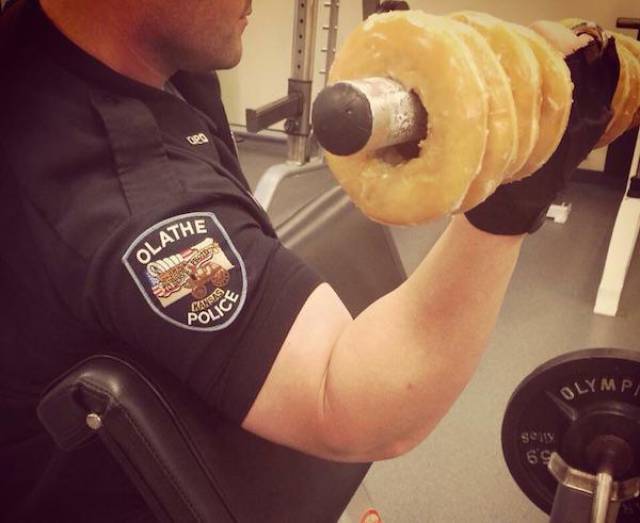 Cop working out with a special kind of dumbbell.