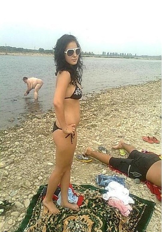 The Person Who Took This Picture Must Have Been Concentrating On The Woman In The Bikini And Didn't Even Notice What Was Behind Her.