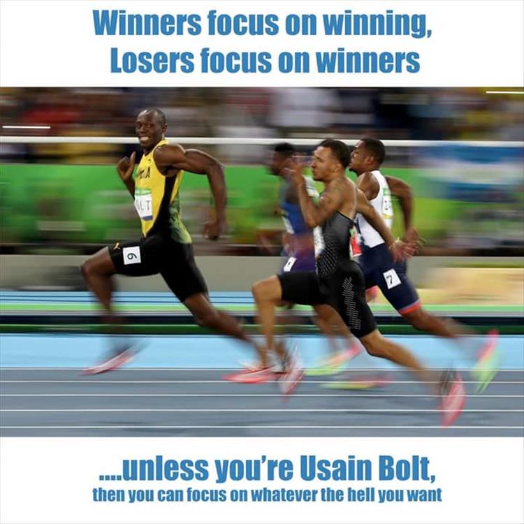 Usain Bolt smiles for the camera mid-race.